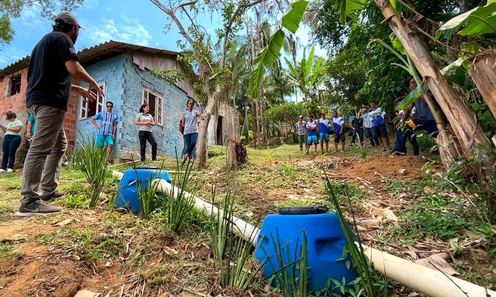 A imagem mostra pessoas em uma casa siuada na ilha de eufrasina para aplicar o projeto de sistema de esgoto